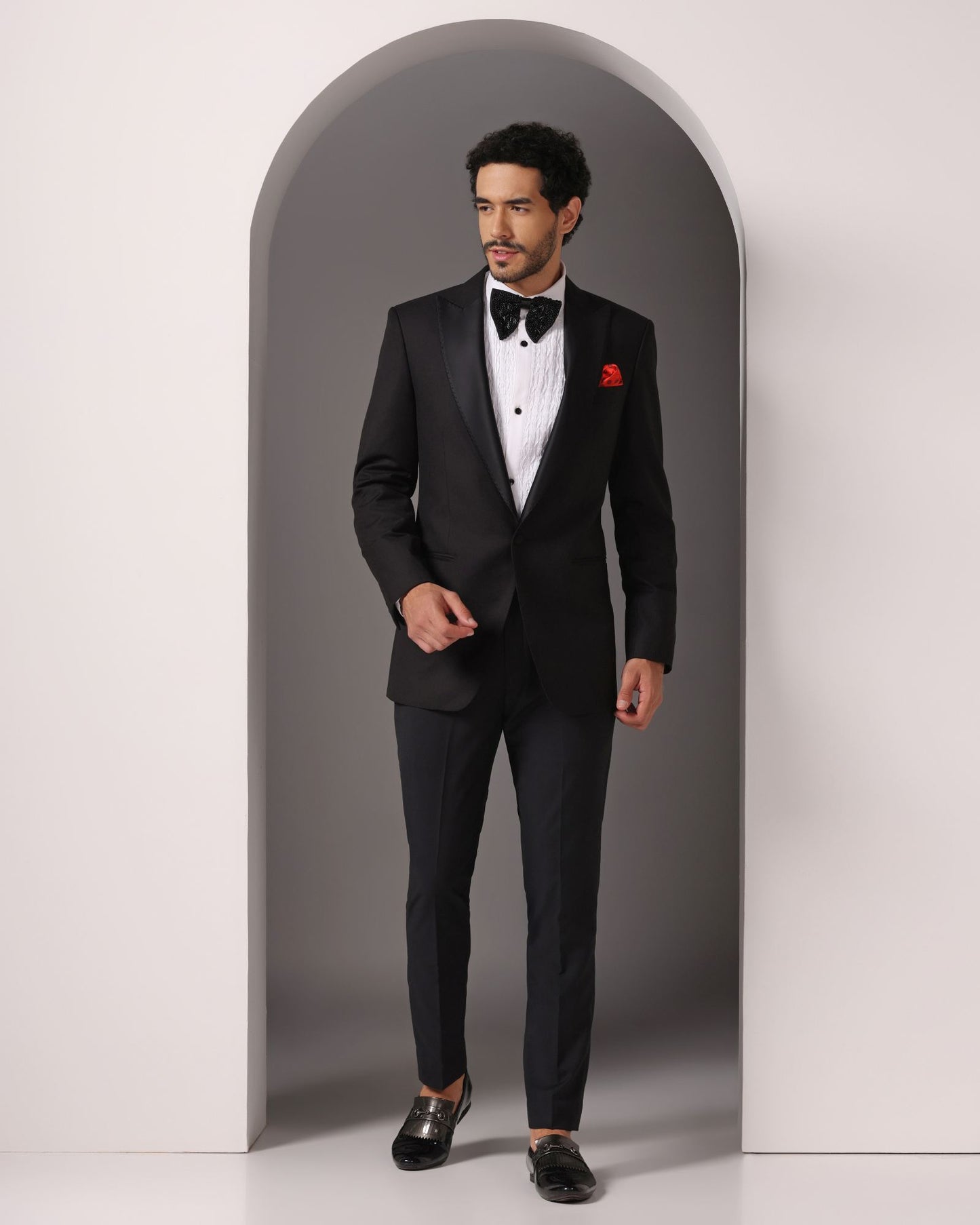 Black single button peak lapel classic tuxedo | Bhavya Bhasin Couture